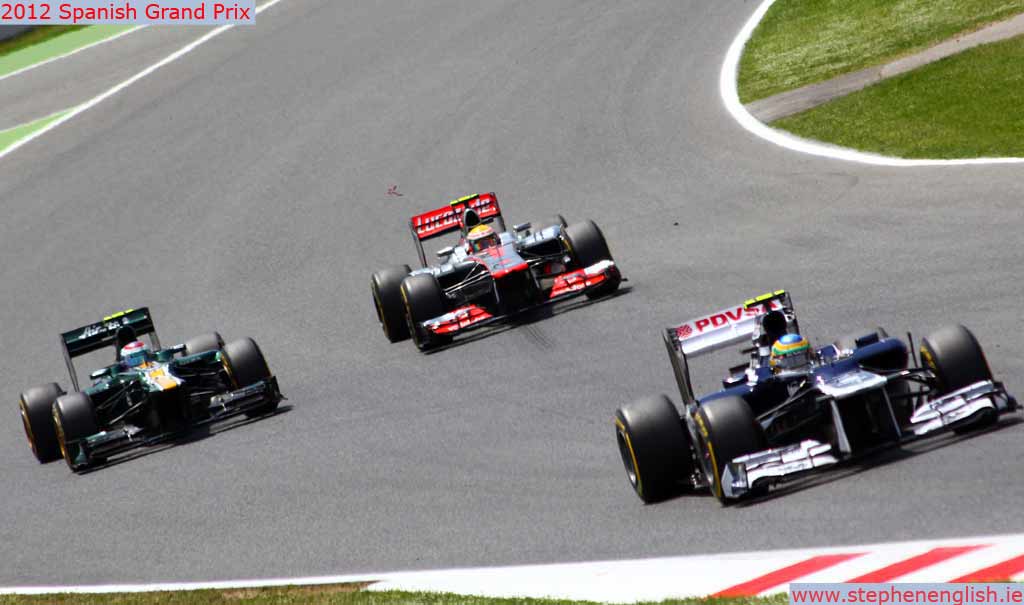 lewis-hamilton-overtakes-vitaly-petrov-with-bruno-senna-in-front-barcelona-race-2012.jpg
